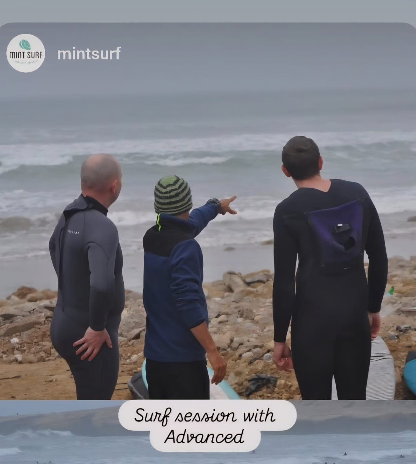 Three surfers watching the Atlantic during a surf session