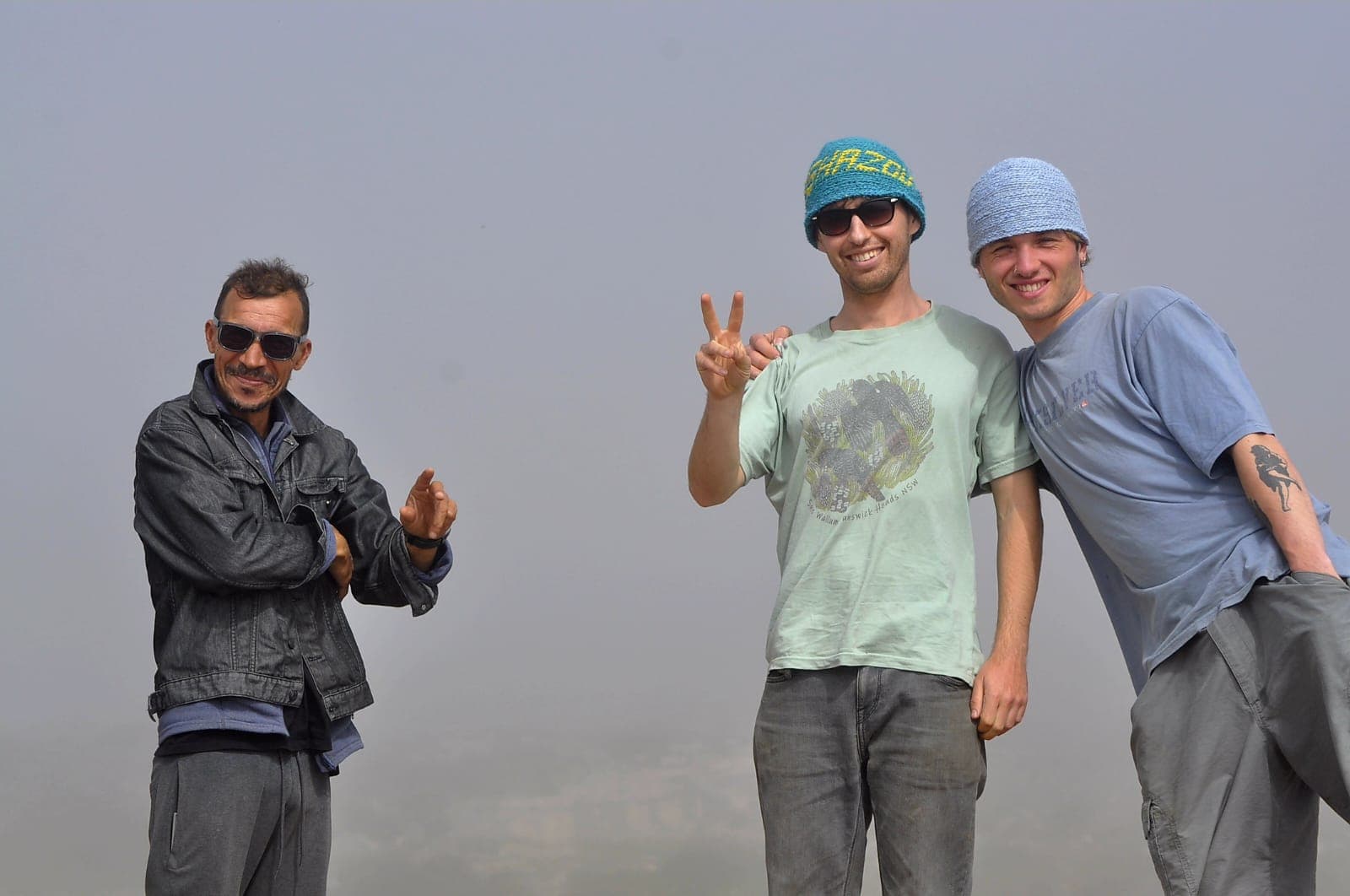 Surfers and guide posing together after a surf session